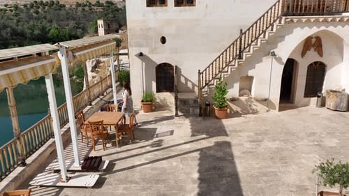 Woman Enjoying Tranquil River View on Balcony