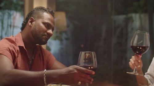 Couple Enjoying Dinner with Wine at Night