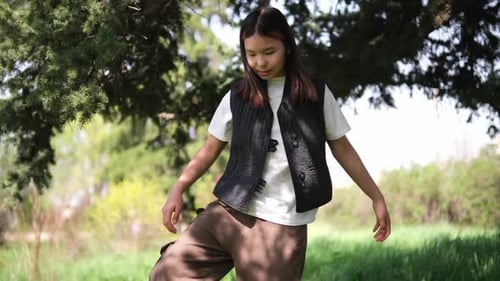 Teen Stretching Her Leg on Grassy Field