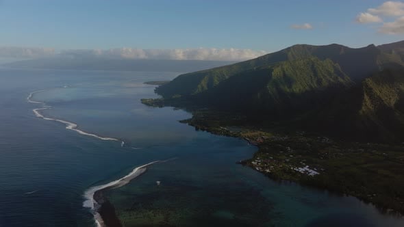 Morning sunrise volcano island mountains Teahupoo Tahiti aerial drone ...