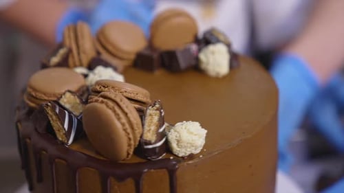 Amazing decorated chocolate cake rotating at the stand. Beautiful tasty dessert production