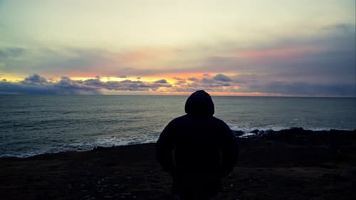 Tracking Shot Of A Man Walking Towards The Sea