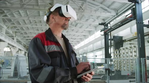 Factory Engineer Using Digital Tablet and VR Headset
