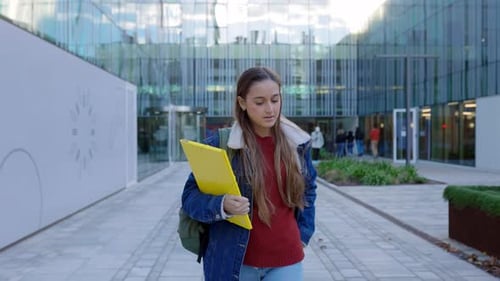 Young Caucasian Student Girl Using Phone at College Campus After Classes