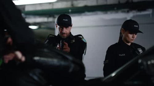 Police Officers Questioning Man at Night in Parking Garage