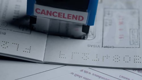Close Up Shot of Person Identity Document Shot of Open Passport Laying on the Table Stamp with