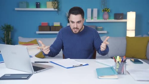 Tired of working in the home office, the man thinks about ideas and gets angry.