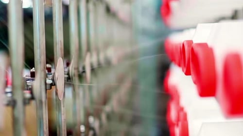 Close Up Slow Motion of Thread Running Through Textile
