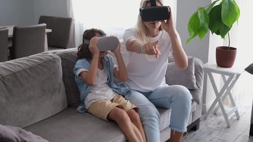 Woman and Child Enjoying Virtual Reality Headsets at Home