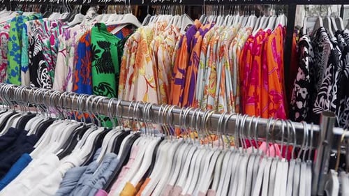 A Vibrant Collection of Stylish Summer Shirts Displayed on Hangers in a Retail Store