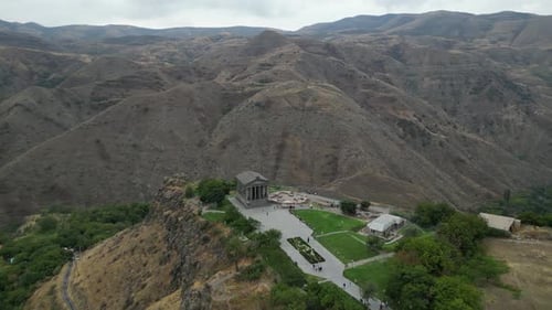 Aerial orbits rebuilt Roman Garni Temple on canyon edge in Armenia