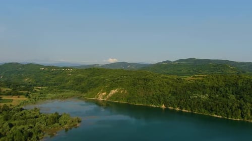 Lake Butoniga water dam in Croatia shore approach, Aerial drone left pan reveal shot