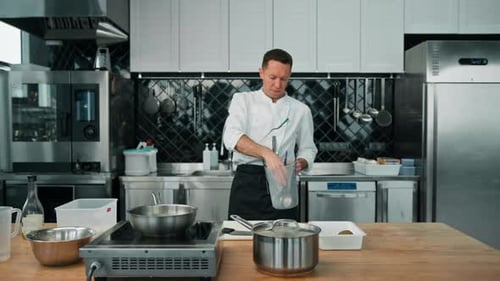 professional kitchen satisfied chef chef looking at kitchen utensils cooking concept