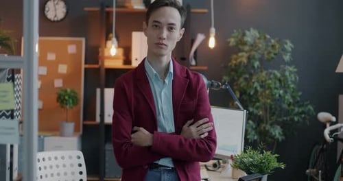 Slow Motion Portrait of Male Employee Standing in Office Workplace with Arms Crossed and Looking at
