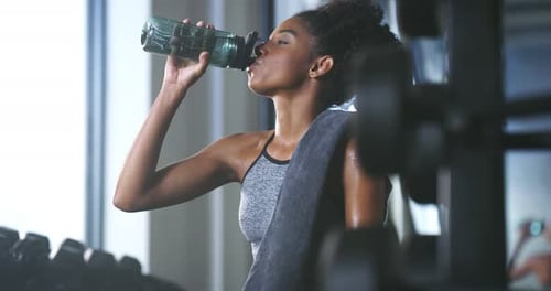 Happiness, tired and gym woman drinking water, beverage and relax after training exercise