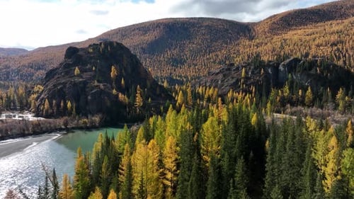 Turquoise river flowing through a scenic autumn forest