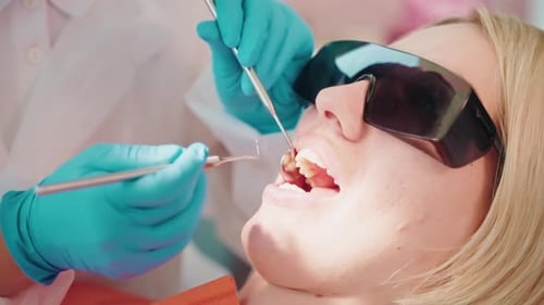 Curing Toothache in Modern Stomatology Clinic Closeup of Face Female Patient and Hands of Dentist