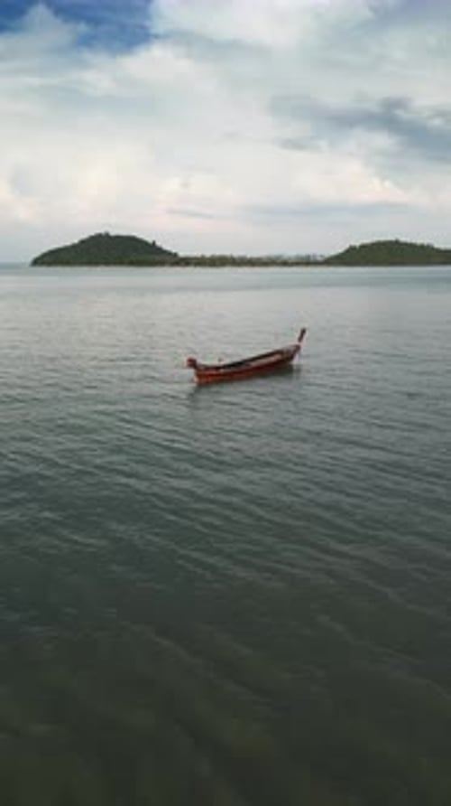 Vertical Video Drone Shot of a Tropical Coast with Wooden Sailboats Near the Shore