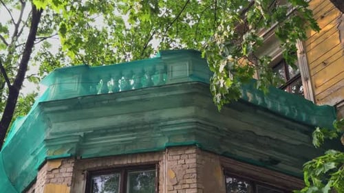 Green Construction Netting Located on the Building Terrace Which is Completely Surrounded By Lush