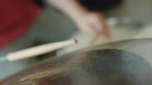 Drumstick Strikes Cymbal Creating a Rhythmic Beat