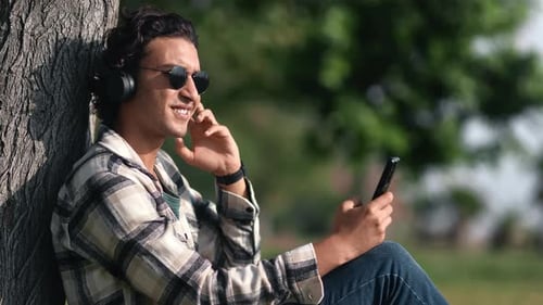 Relaxed Arabic Man Listening Music Summer Sunny Park Use Smartphone Headphones Enjoy Outdoor Leisure