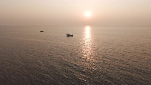 Atmospheric landscape shot of the open ocean under a hazy, sun-drenched sky.