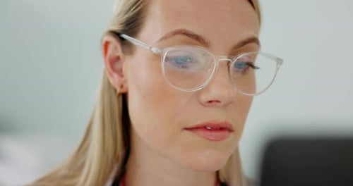 Woman Looks at Computer Screen Wearing Glasses
