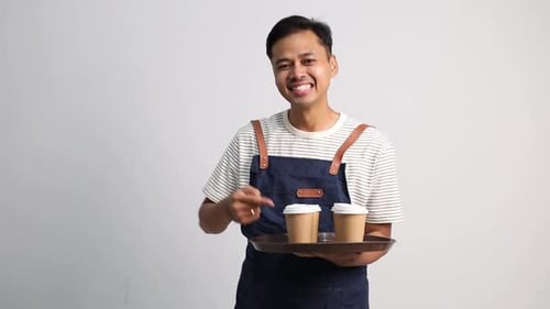Smiling Man Serving Coffee on Tray Indoors