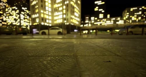 City Lights Reflect on Wet Pavement During a Bustling Nighttime Adventure