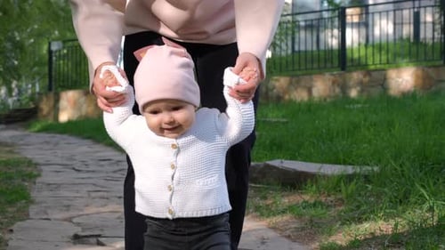 Adorable Baby Learning to Walk in the Park
