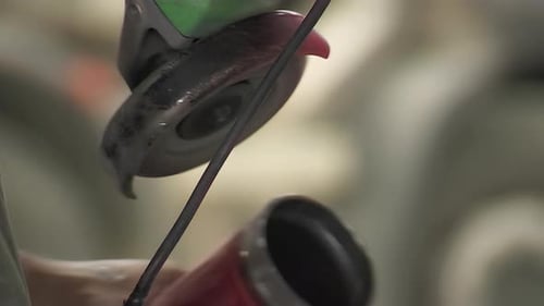 Angle Grinder on Metal Pipe Generates Sparks