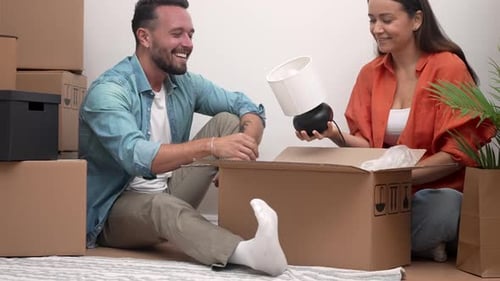 Couple Enjoying Unpacking Boxes in New Apartment Building a Life Together Moving Day Happiness