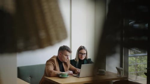 Coworkers Discuss Chart Graphics in Office Watching Report on Laptop Display Brainstorming