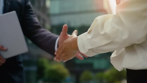 Two Multiethnic Business People Shaking Hands in City Unrecognizable Female Male Partnership Deal