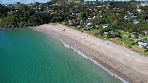 Sandy Shoreline Of Palm Beach And Crystal Clear Water In Summer In Auckland, New Zealand. - aerial s