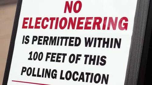 No Electioneering is Permitted Within 100 Feet of this Polling Location Sign Close Up with Sun Glair