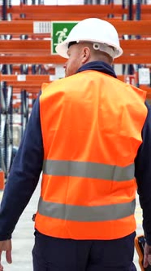 Warehouse worker walking through logistics center