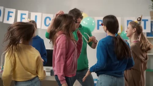 Happy Employees Have Fun in the Office The Team in Festive Hats Celebrate the Common Success Dance