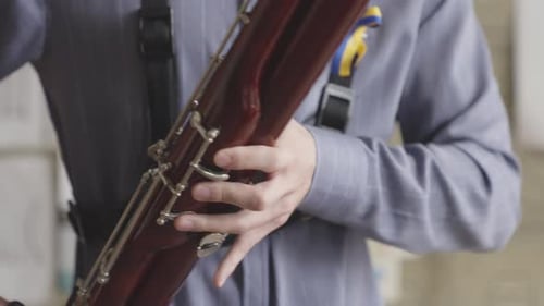 Young male student practice to play Bassoon in Music School. - close up