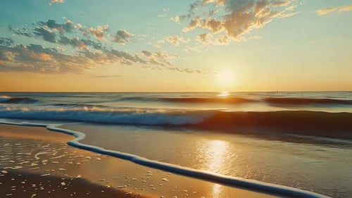 Sunrise over the ocean beach. Gentle waves caress the shore at dawn