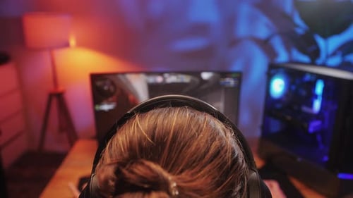 Young Man Has a Video Game Stream or Podcast in Neon Room Male Gamer Playing Online Video Games on