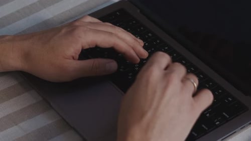 Male Hands Typing on Laptop Keyboard Close Up From Top View