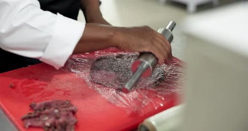 Hands, chef or flatten meat in restaurant to tenderize, enhance flavor or meal prep in food
