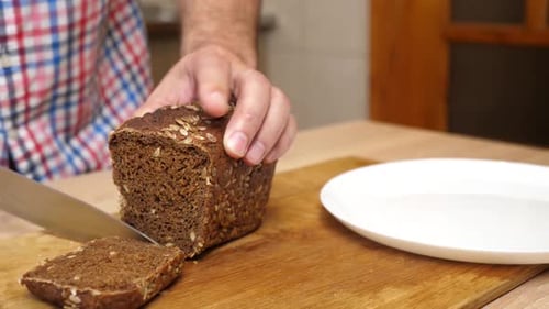 Cutting Seeded Bread on Wooden Board