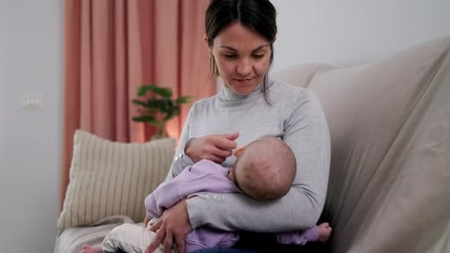 Mother Comforting her Infant at Home