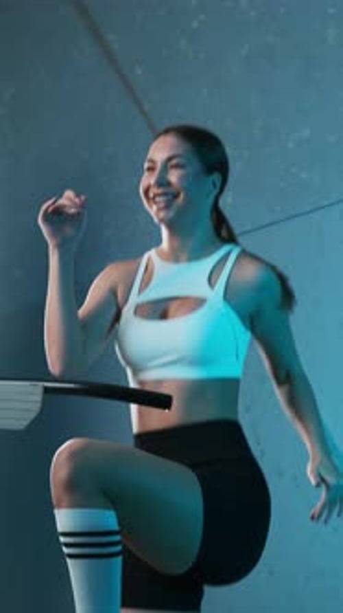 Woman Exercising on Treadmill Indoors