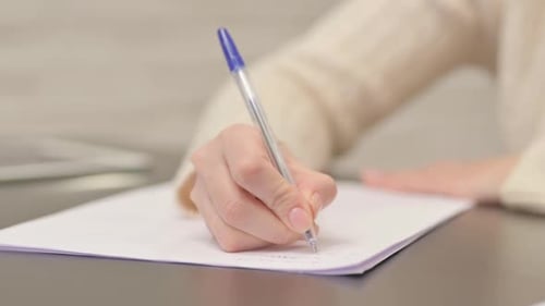 Close up of Woman Writing on Paper