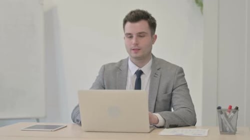 Young Businessman Leaving Office after Work in Evening