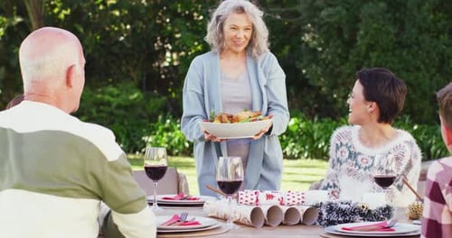 Happy caucasian family having dinner in garden