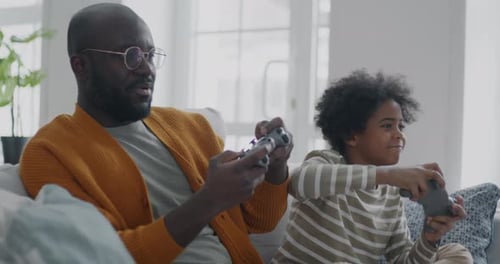 Father and Son Playing Video Games Together